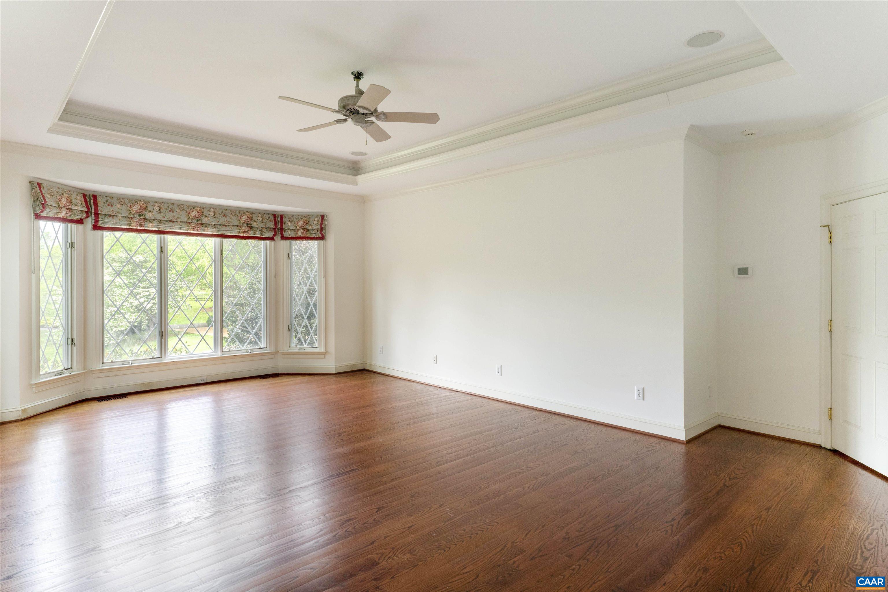 2121 Garth Road Charlottesville, VA 22901 - Photo 26 of 75 a view of an empty room with wooden floor and a window