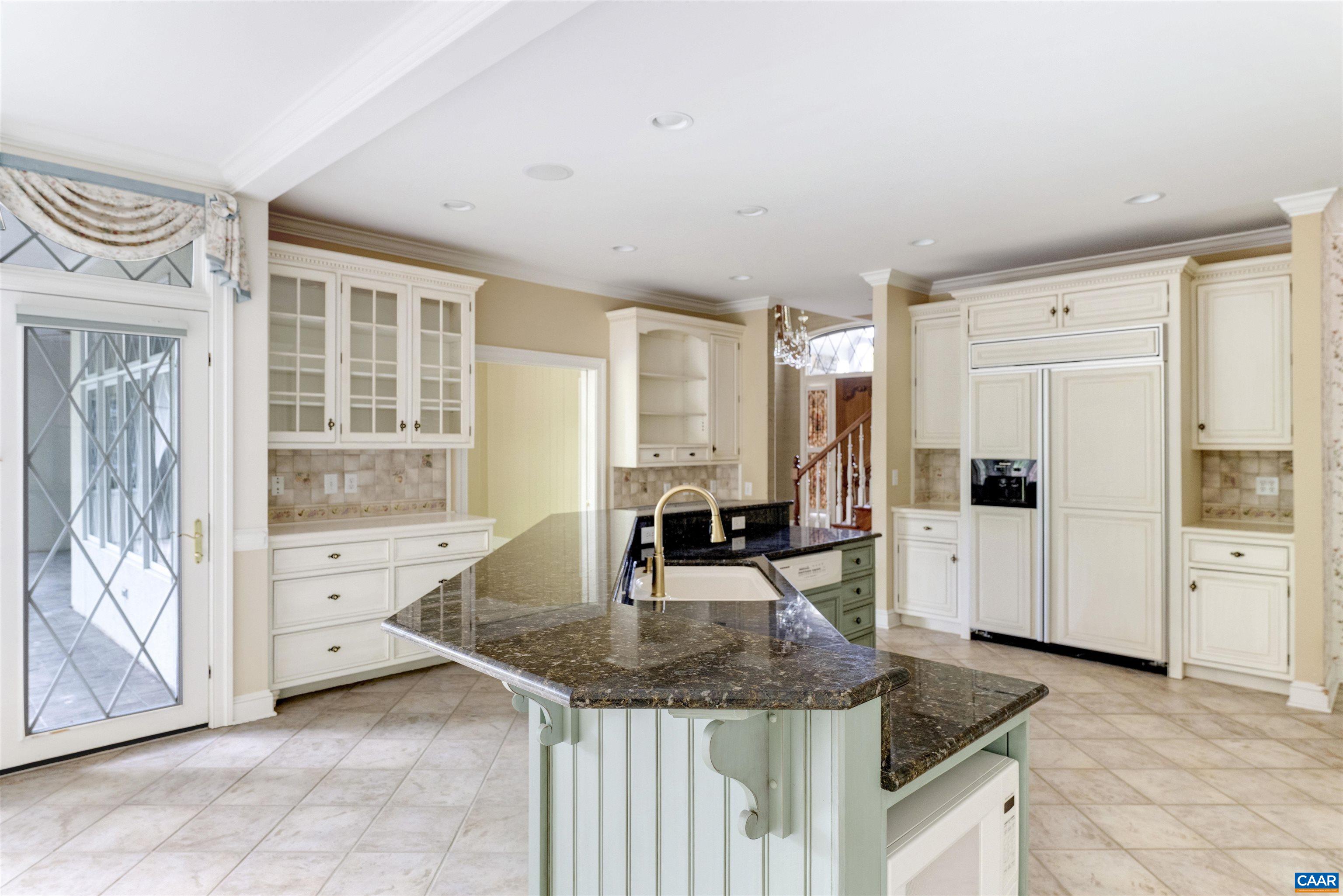 2121 Garth Road Charlottesville, VA 22901 - Photo 61 of 75 a kitchen with granite countertop a sink and a refrigerator
