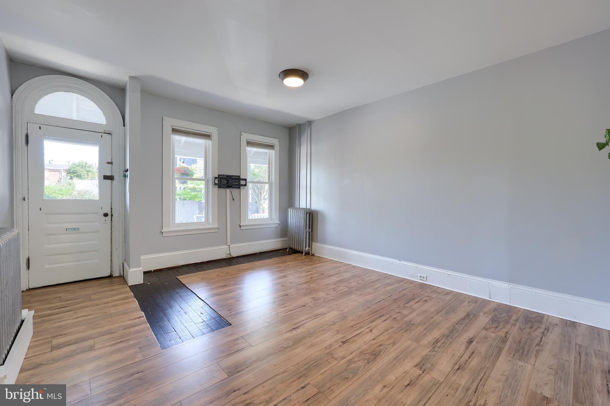 606 North Mary Street Lancaster, PA 17603 - Photo 8 of 33 an empty room with wooden floor and windows