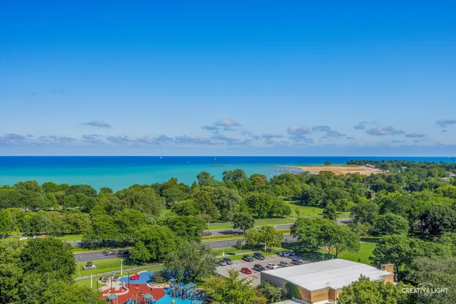 an aerial view of a houses with a yard