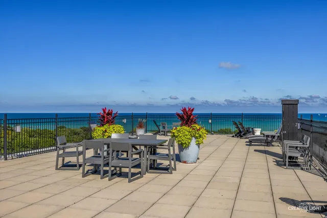 a view of a patio with table and chairs and potted plants