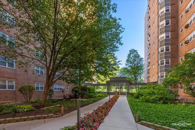 front view of a brick house with a yard