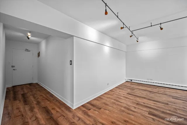 a view of a room with wooden floor