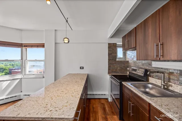 a kitchen with a sink stove and cabinets