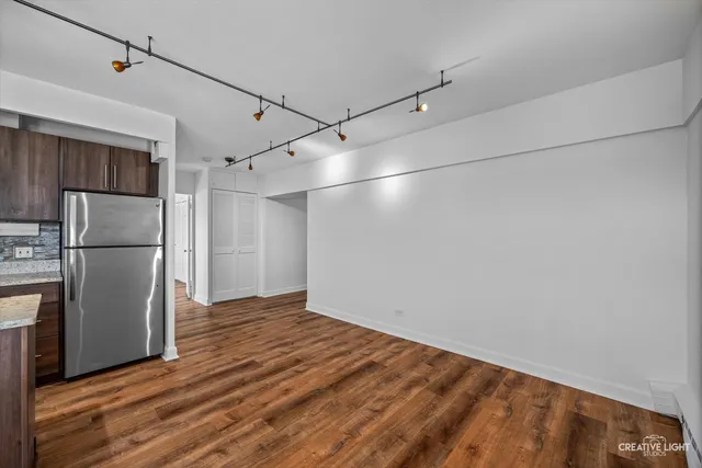 a view of a kitchen with a refrigerator and a microwave