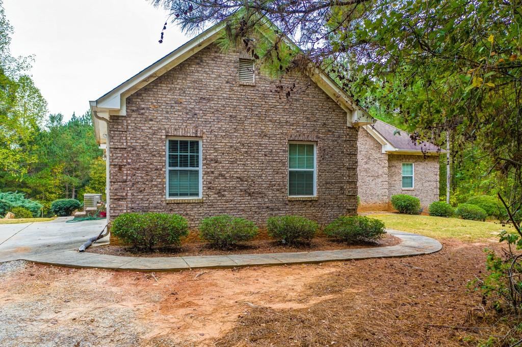 825 Jackson Lake Road Jackson, GA 30233 - Photo 1 of 1 a front view of a house with a yard and garage