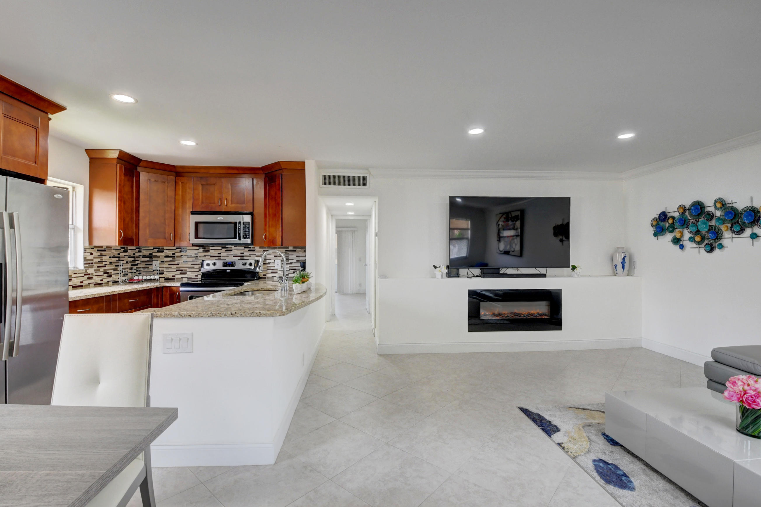 468 Saxony Way Delray Beach, FL 33446 - Photo 3 of 14 a kitchen with stainless steel appliances granite countertop a refrigerator and a stove top oven