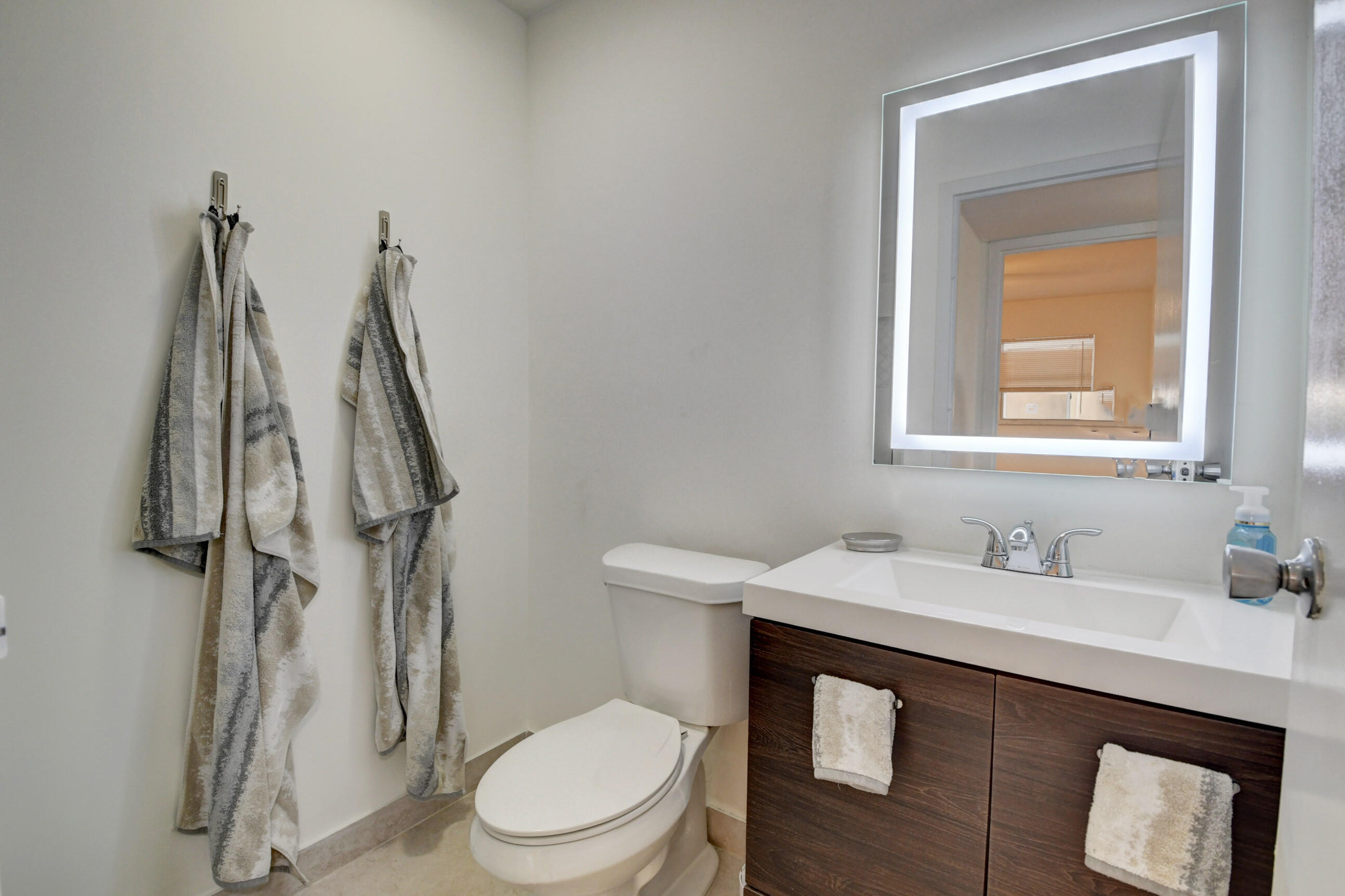 468 Saxony Way Delray Beach, FL 33446 - Photo 6 of 14 a bathroom with a toilet sink and a mirror