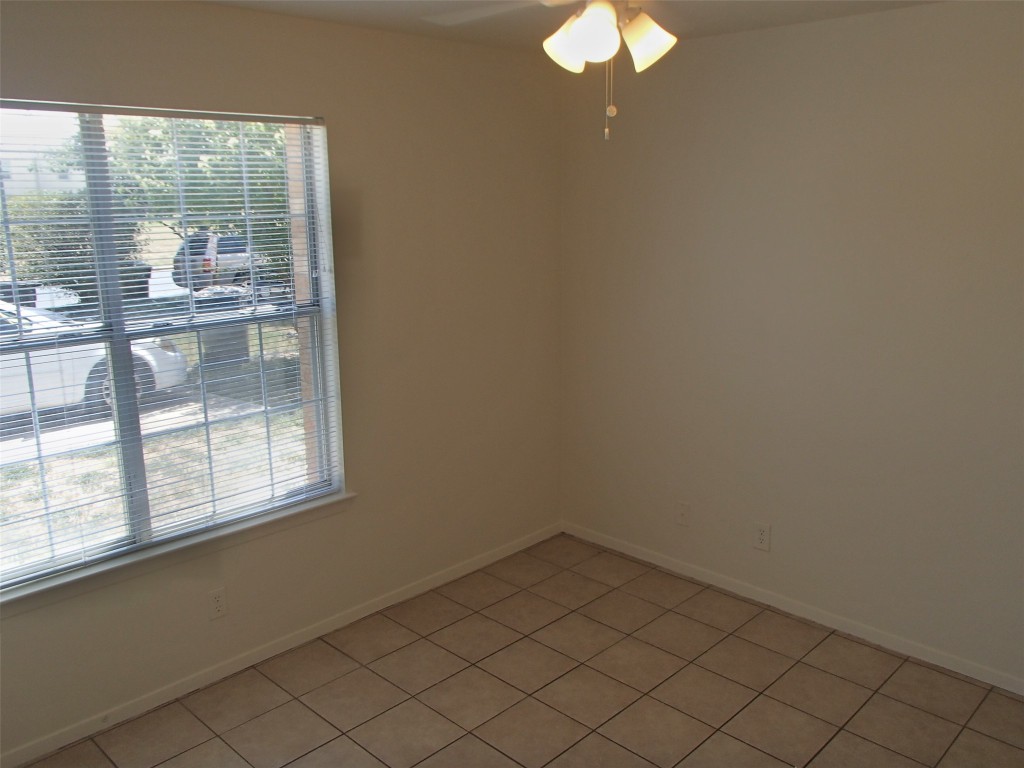 2202 Katy Lane, Unit A Georgetown, TX 78626 - Photo 7 of 9 Spare room with ceiling fan and light tile patterned floors