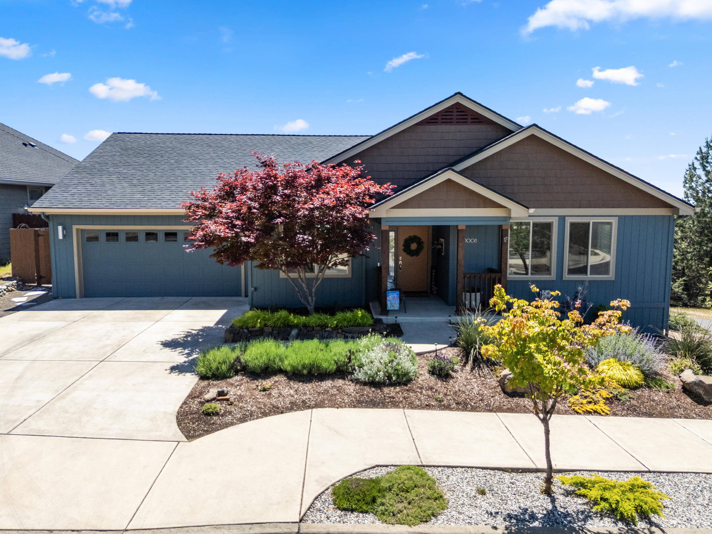 1008 Azure Way Eagle Point, OR 97524 - Photo 1 of 59 a front view of a house with a garden