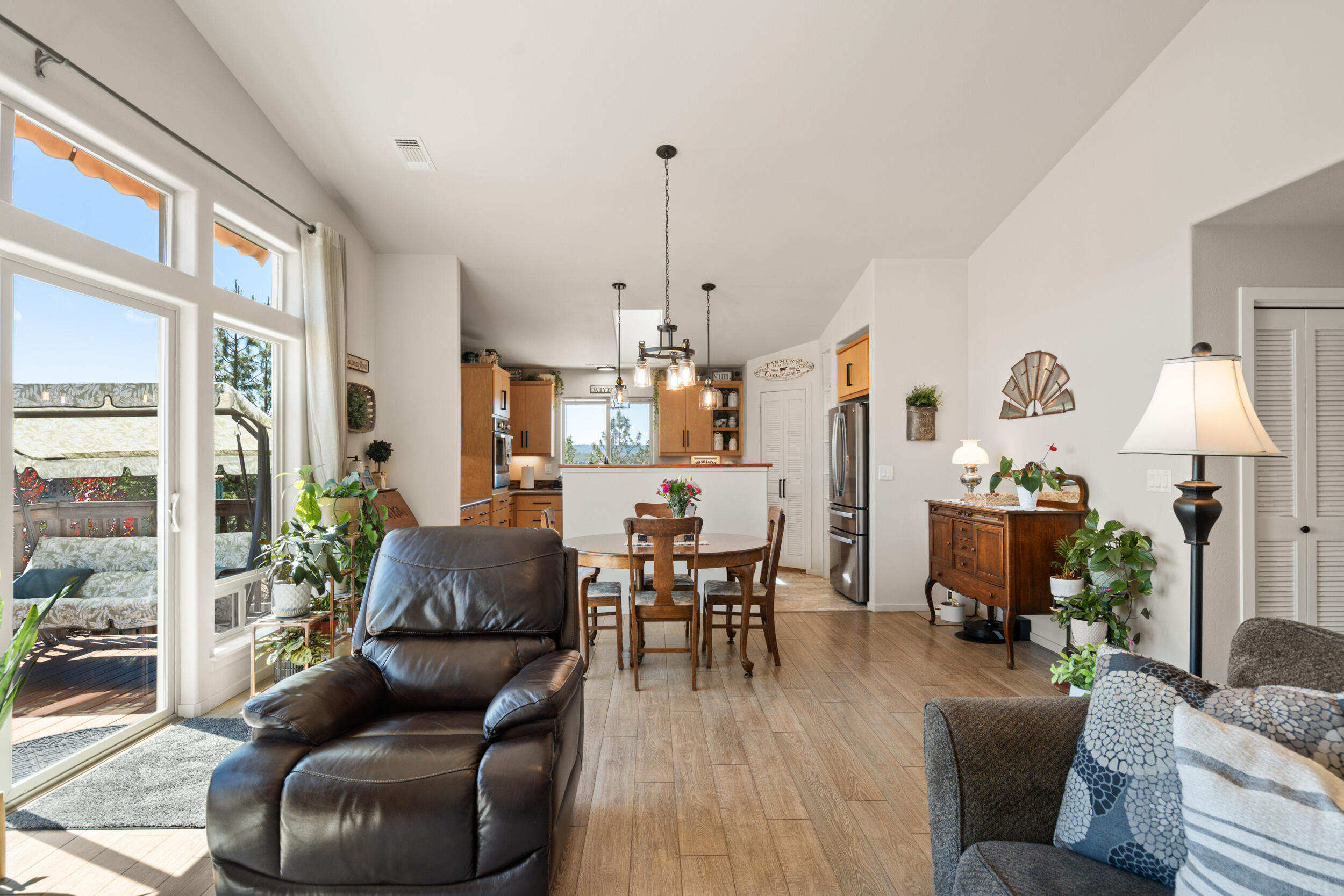 1008 Azure Way Eagle Point, OR 97524 - Photo 14 of 59 a living room with furniture a dining table and a chandelier