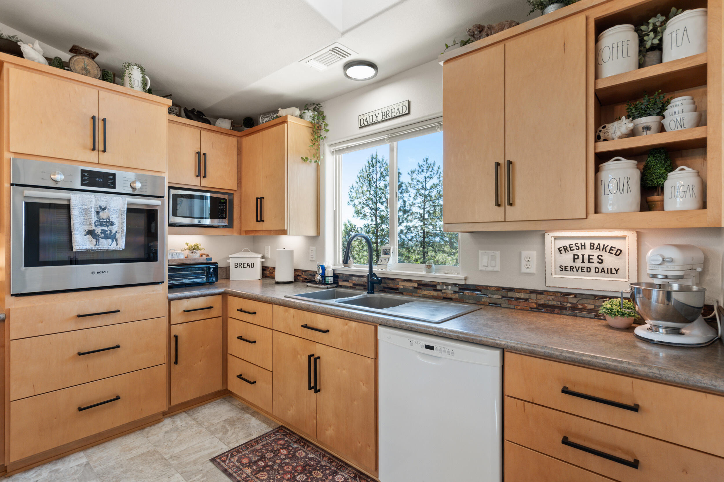 1008 Azure Way Eagle Point, OR 97524 - Photo 17 of 59 a kitchen with stainless steel appliances granite countertop a sink and cabinets