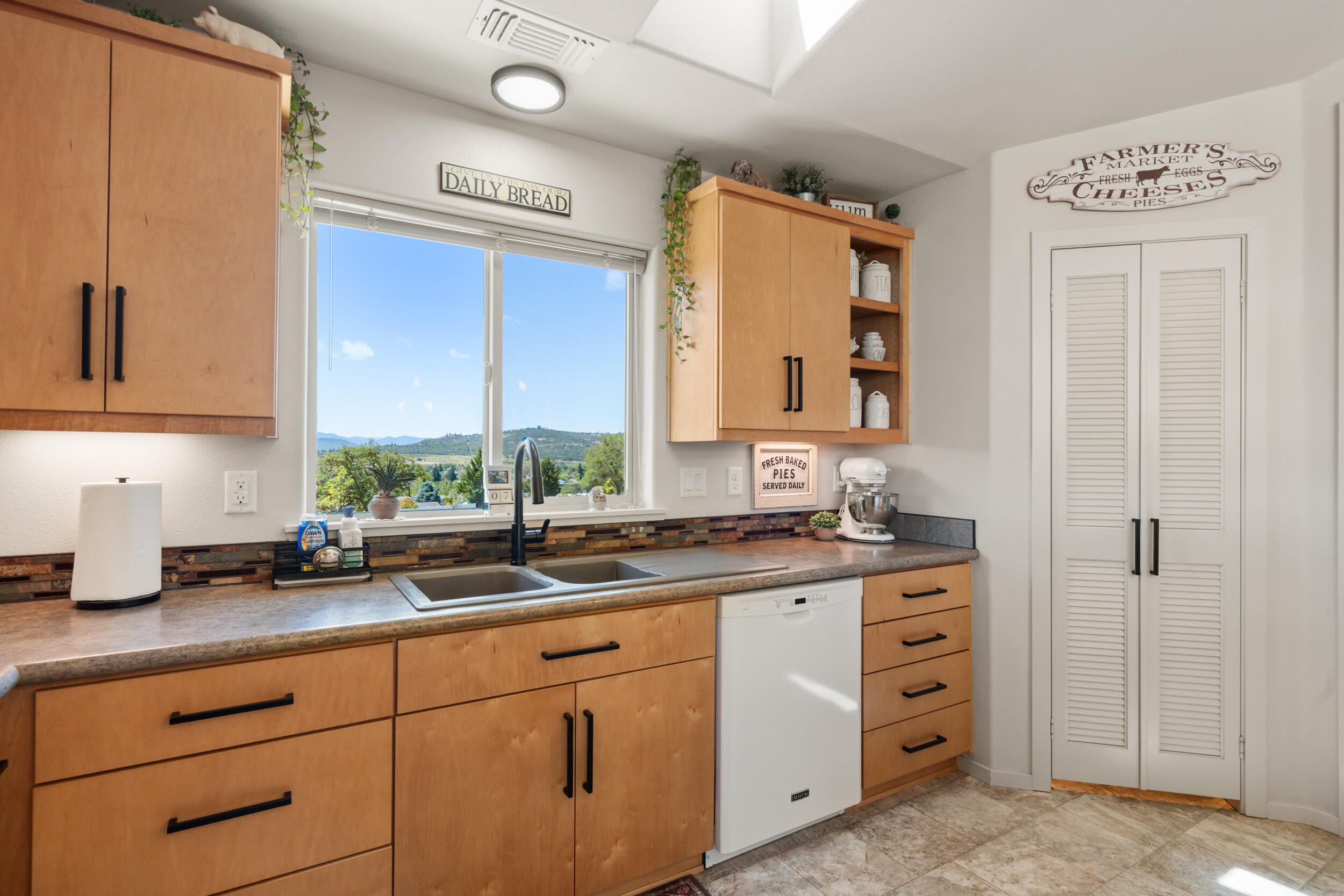 1008 Azure Way Eagle Point, OR 97524 - Photo 18 of 59 a kitchen with cabinets appliances a sink and a window
