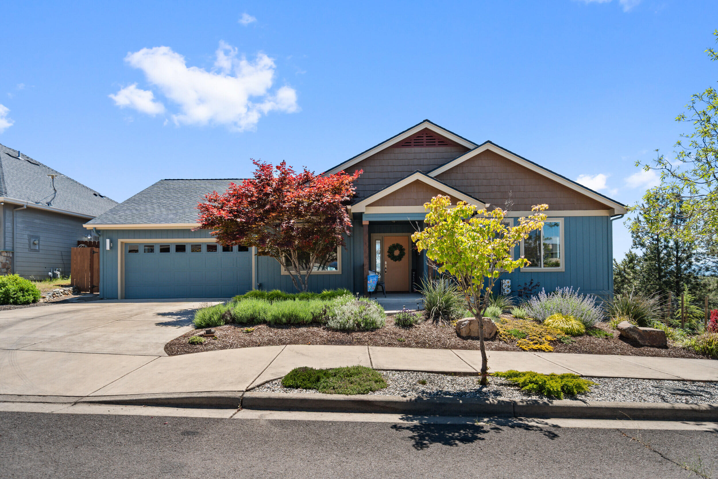 1008 Azure Way Eagle Point, OR 97524 - Photo 2 of 59 a front view of a house with a yard and garage
