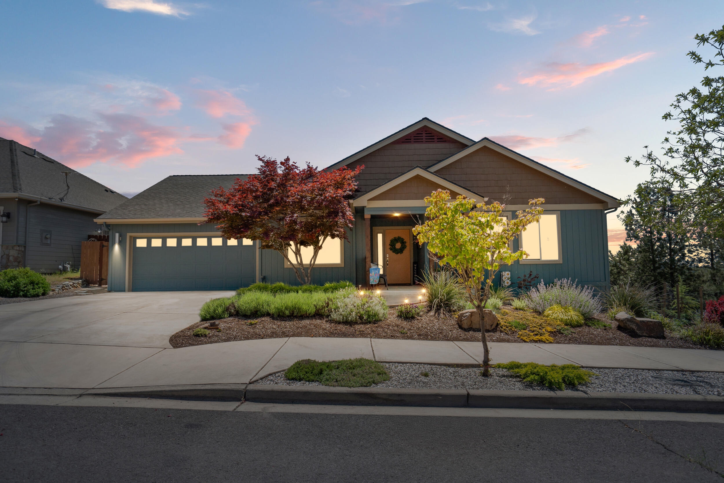 1008 Azure Way Eagle Point, OR 97524 - Photo 3 of 59 a front view of a house with a yard and a garage
