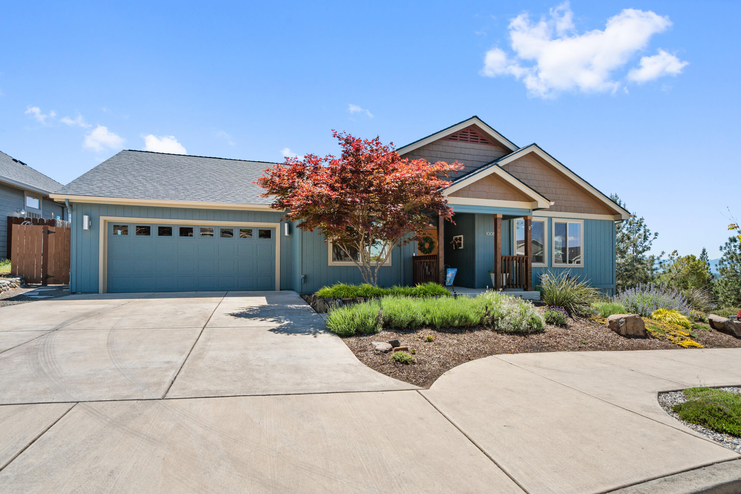 1008 Azure Way Eagle Point, OR 97524 - Photo 4 of 59 a front view of a house with a yard and a garage