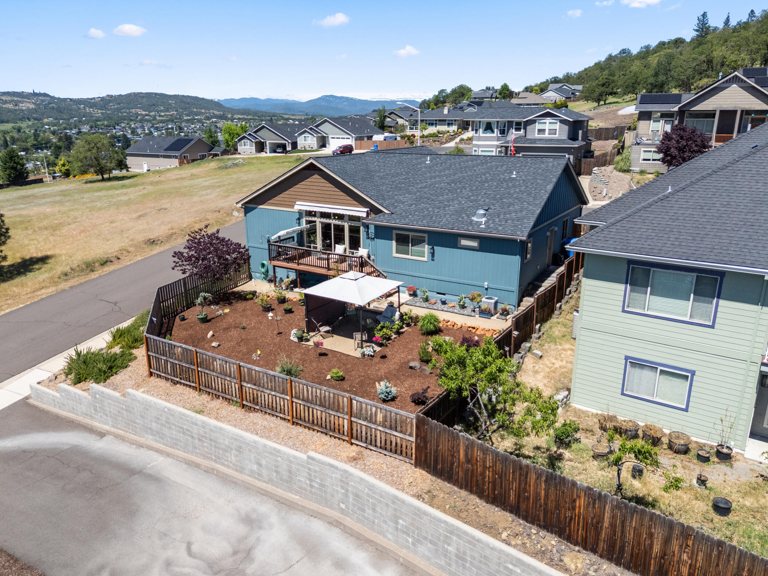 1008 Azure Way Eagle Point, OR 97524 - Photo 44 of 59 an aerial view of a house with a garden and mountain view