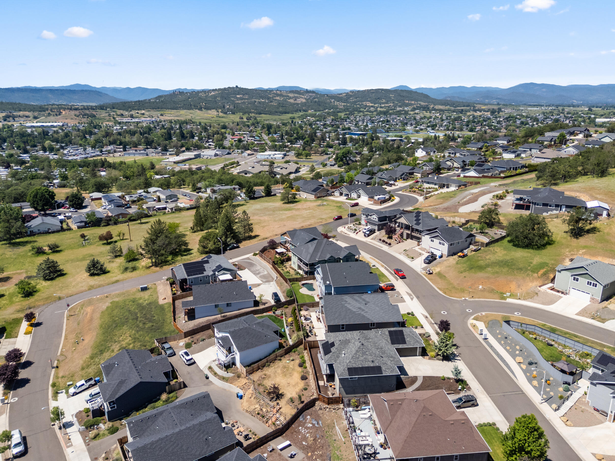 1008 Azure Way Eagle Point, OR 97524 - Photo 54 of 59 an aerial view of a city with lots of residential buildings and mountain view in back