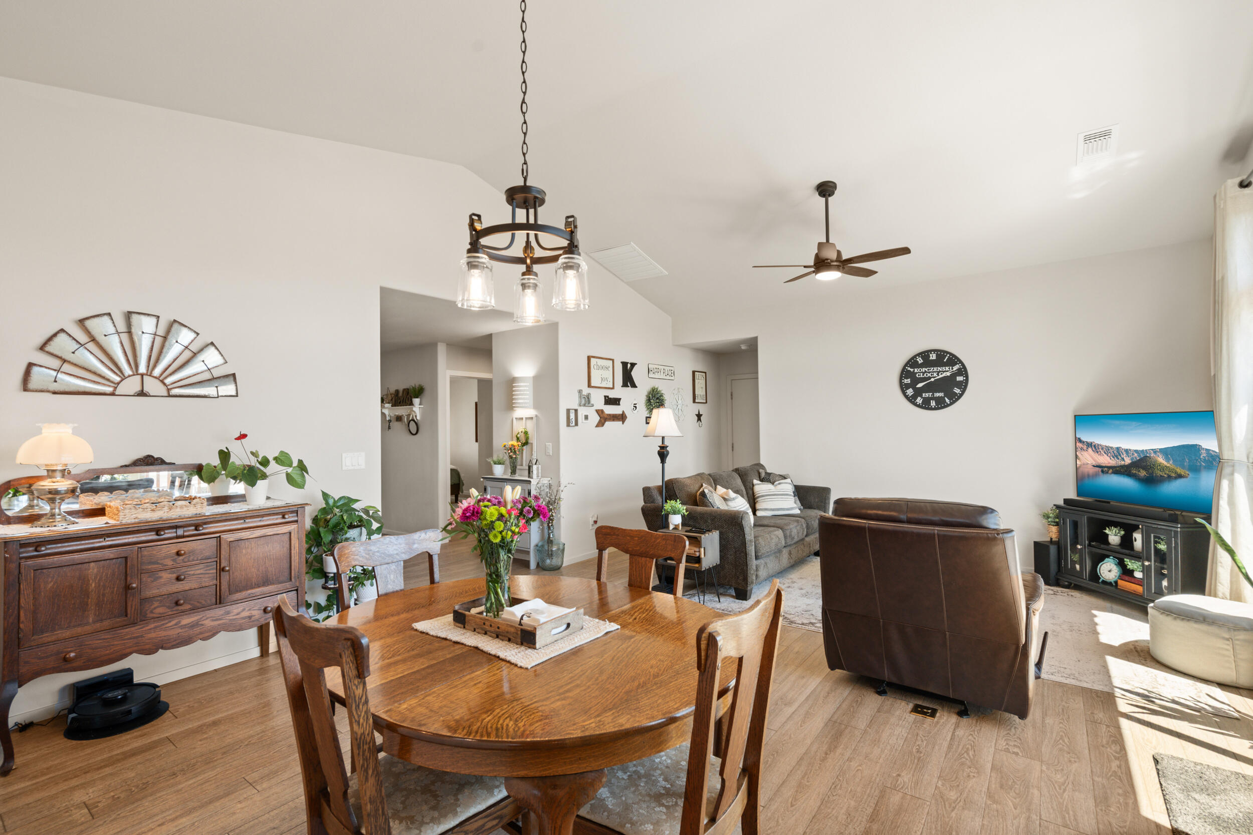 1008 Azure Way Eagle Point, OR 97524 - Photo 10 of 59 a view of a dining room with furniture a chandelier and wooden floor