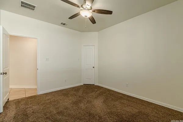 a view of a room with a ceiling fan