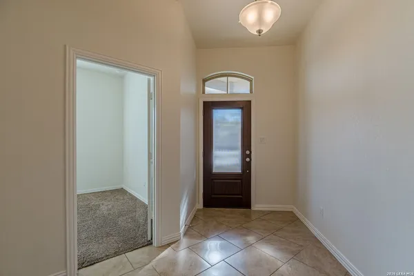 an empty room that has a mirror in it