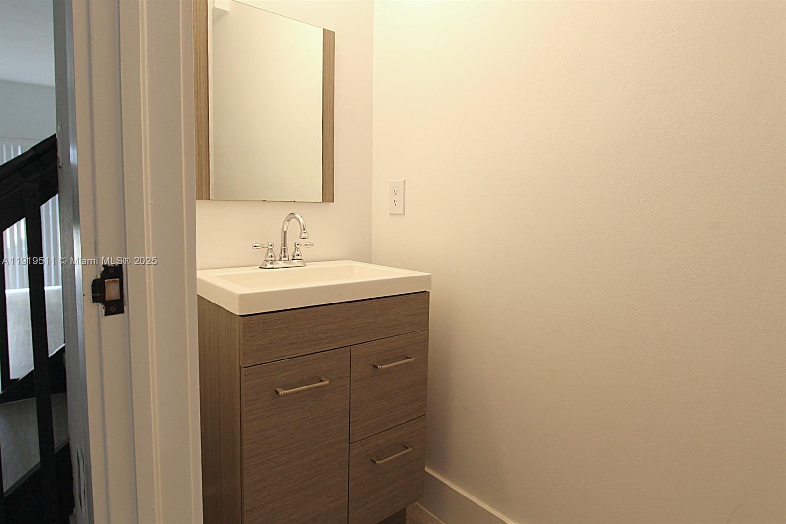9390 Southwest 222nd Way, Unit 9390 Cutler Bay, FL 33190 - Photo 15 of 32 a bathroom with a sink and a mirror