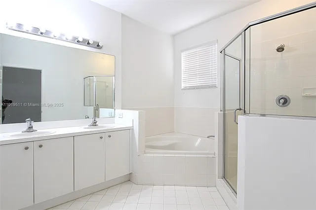 a bathroom with a tub sink and mirror