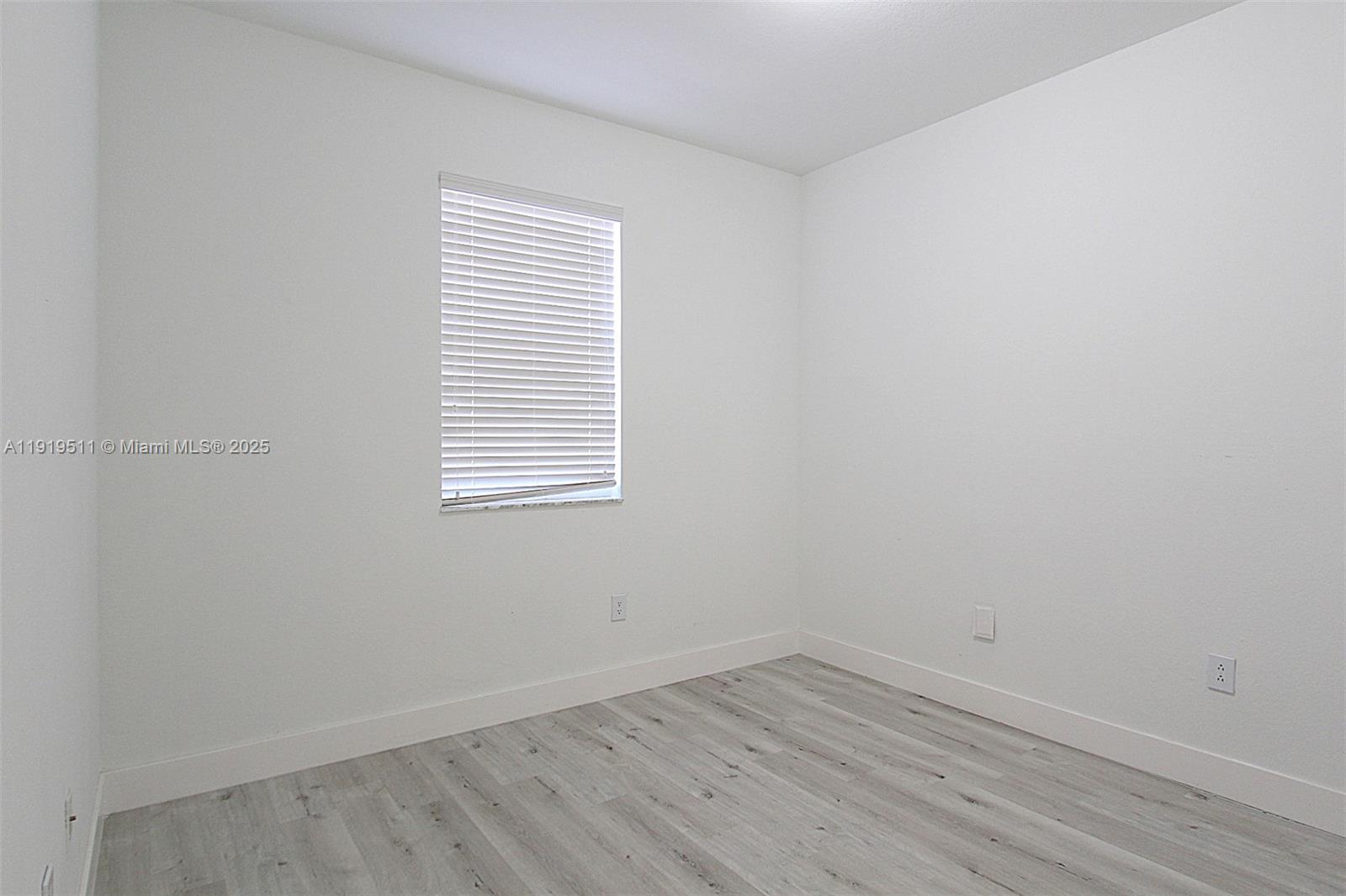 9390 Southwest 222nd Way, Unit 9390 Cutler Bay, FL 33190 - Photo 22 of 32 wooden floor in an empty room
