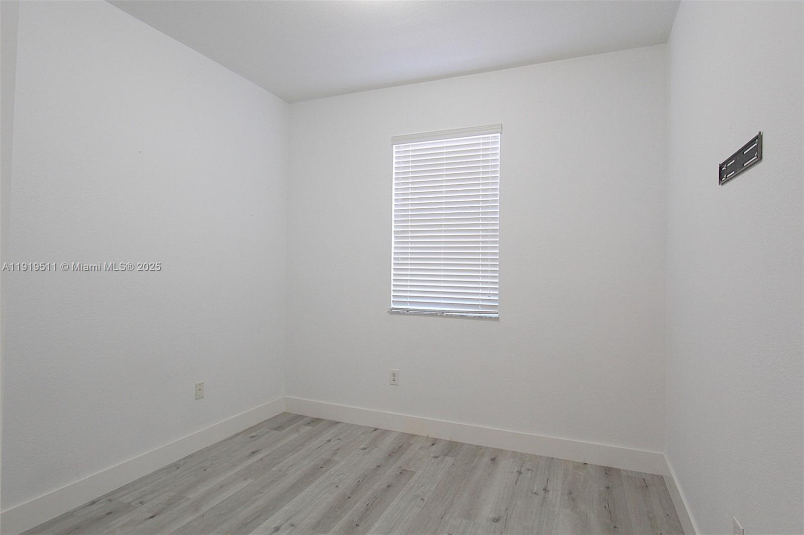 9390 Southwest 222nd Way, Unit 9390 Cutler Bay, FL 33190 - Photo 26 of 32 an empty room with a window