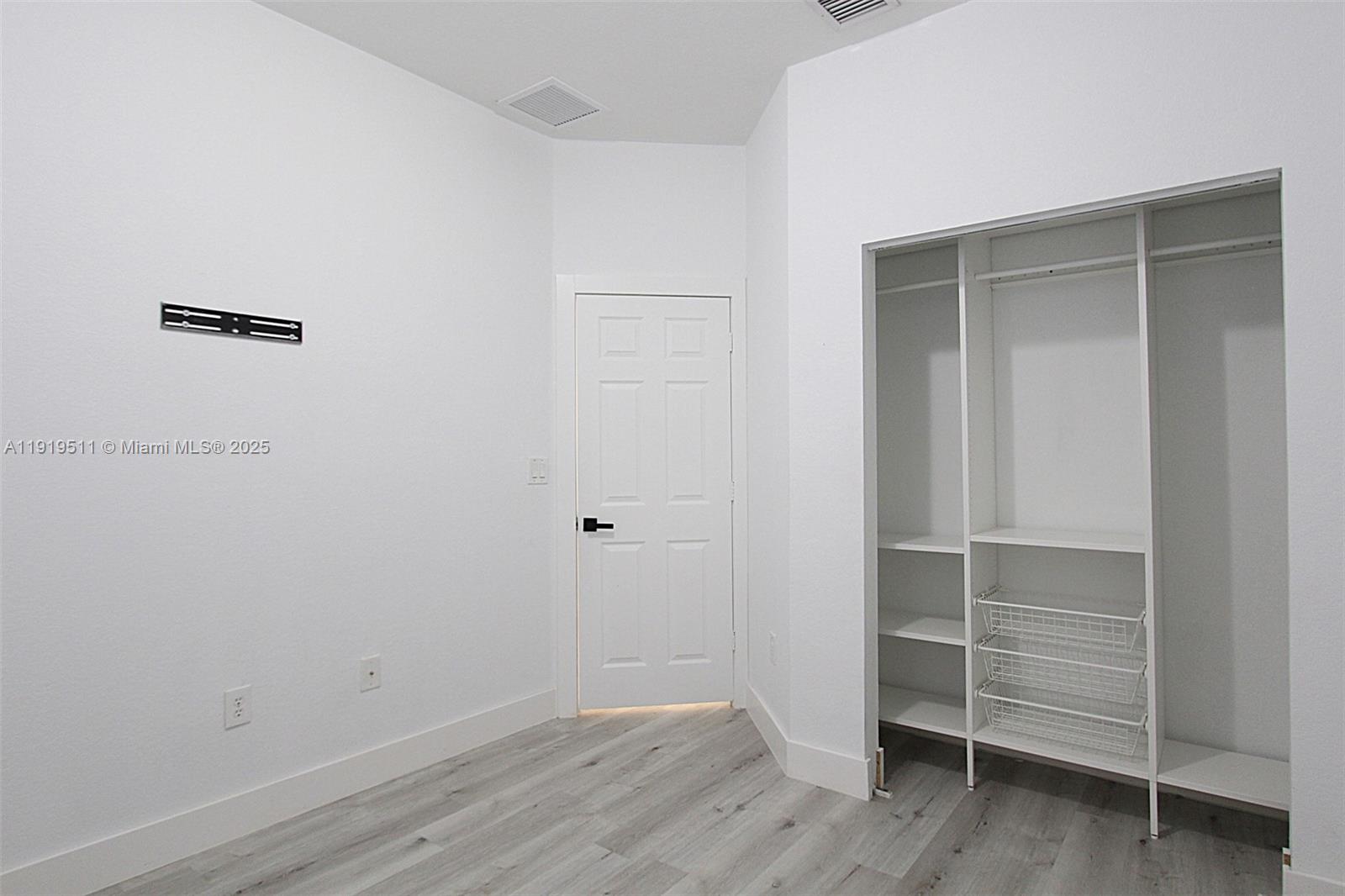 9390 Southwest 222nd Way, Unit 9390 Cutler Bay, FL 33190 - Photo 27 of 32 a view of walk in closet with empty racks