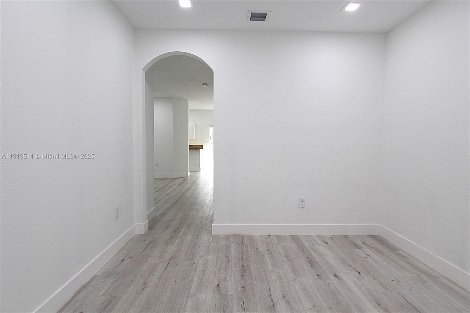 9390 Southwest 222nd Way, Unit 9390 Cutler Bay, FL 33190 - Photo 4 of 32 a view of a room with wooden floor and a window