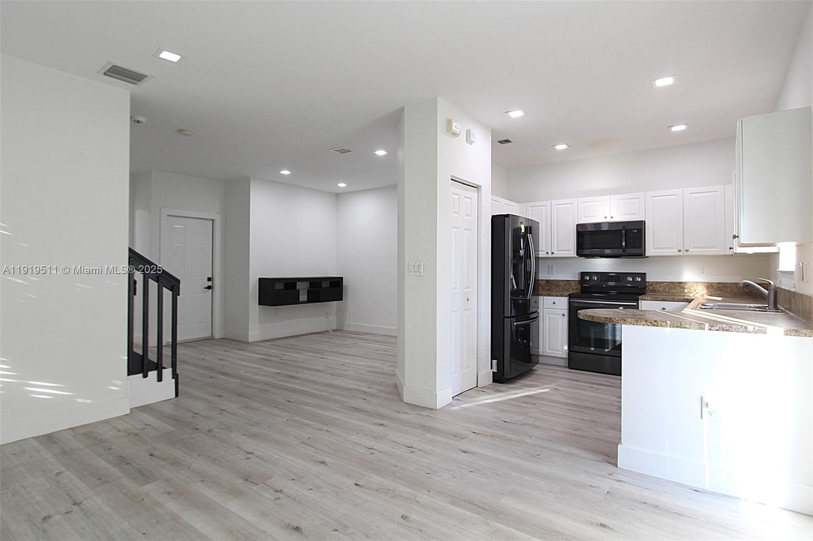 9390 Southwest 222nd Way, Unit 9390 Cutler Bay, FL 33190 - Photo 10 of 32 a kitchen with stainless steel appliances granite countertop a refrigerator and a stove top oven