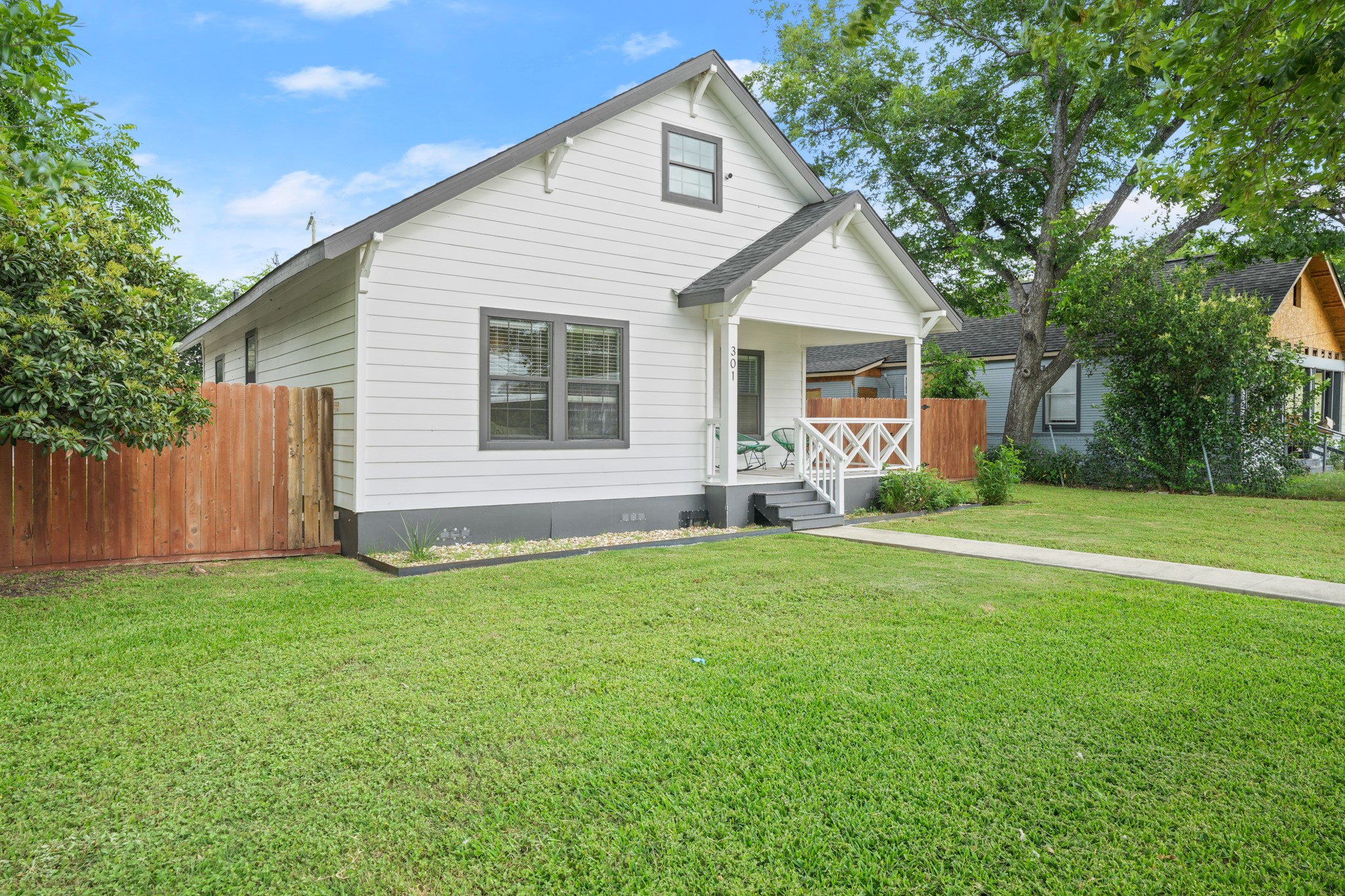 301 Old Thorndale Road Taylor, TX 76574 - Photo 28 of 29 A charming home with a welcoming front porch, nestled amidst verdant landscaping.