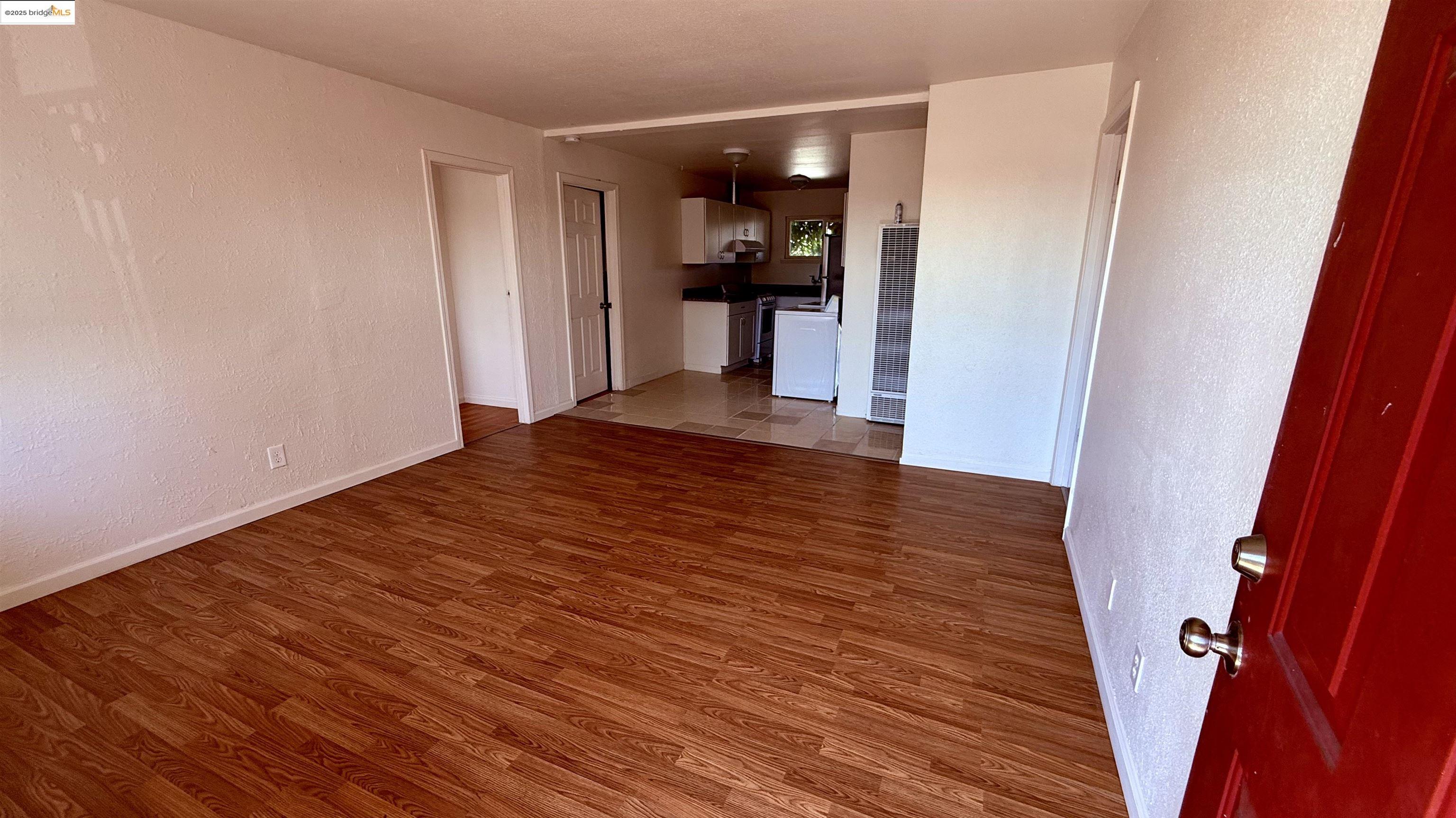 10100 Walnut Street, Unit 3 Oakland, CA 94603 - Photo 11 of 11 a view of a hallway view with wooden floor and a refrigerator