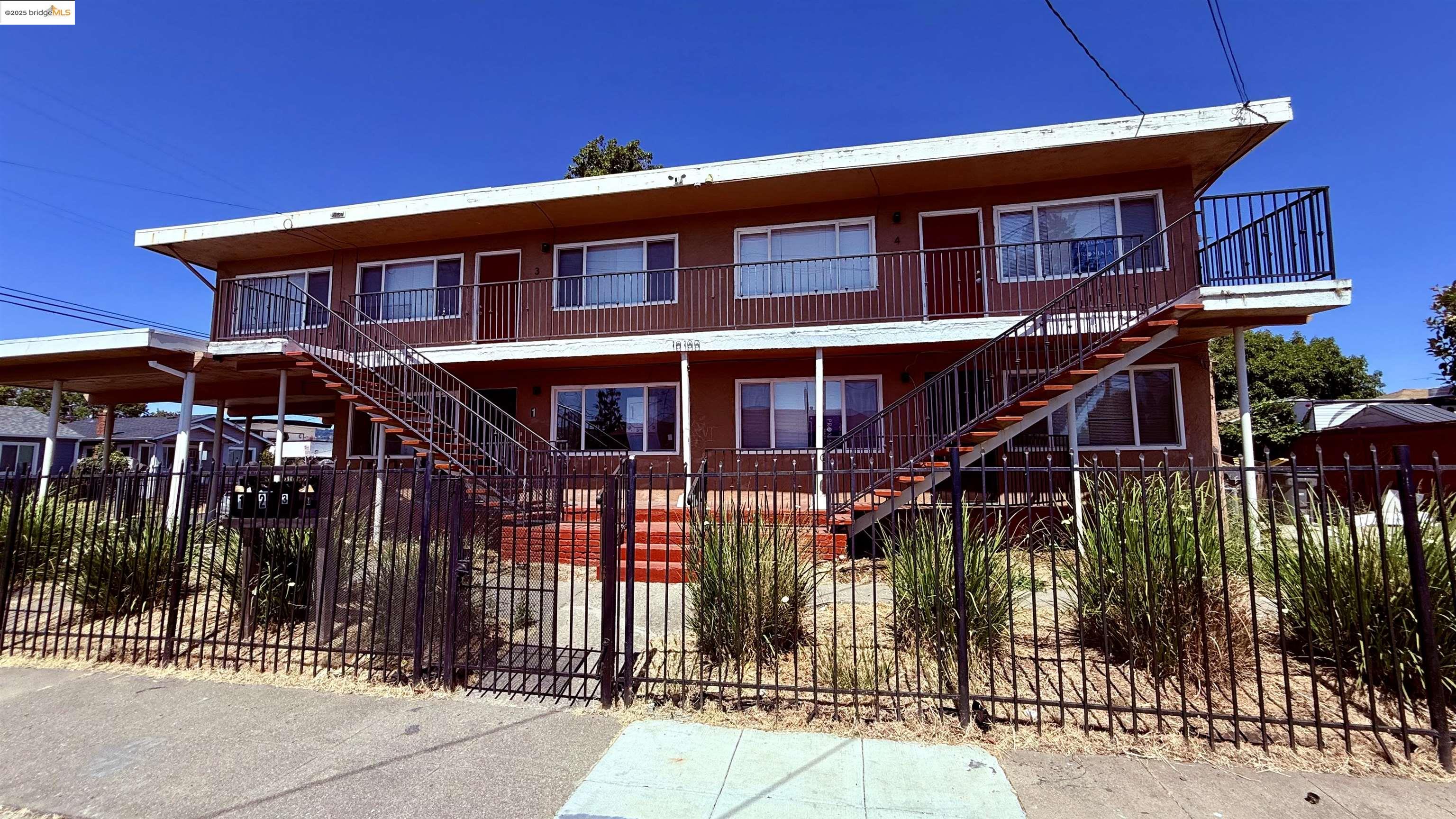 10100 Walnut Street, Unit 3 Oakland, CA 94603 - Photo 2 of 11 a front view of a house with a small yard