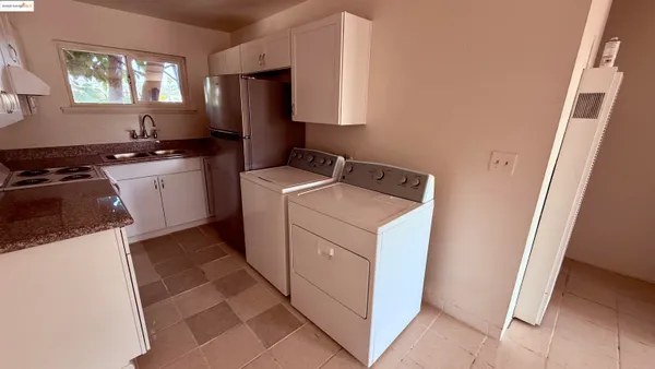 a kitchen with a cabinets and a stove top oven