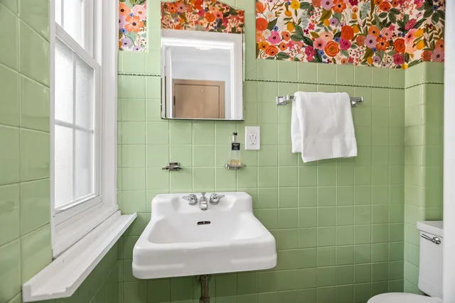 a bathroom with a sink toilet and mirror