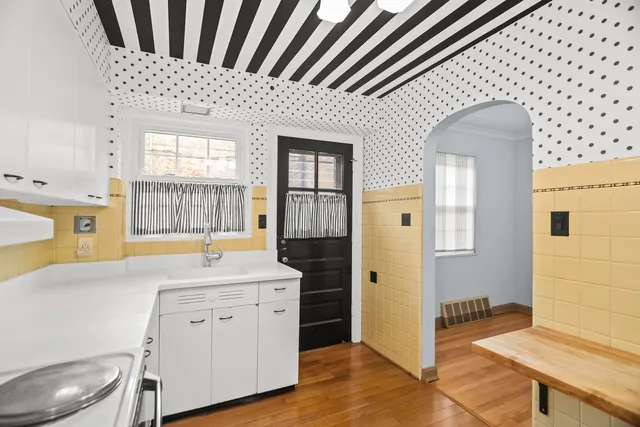 a spacious bathroom with a granite countertop sink and a mirror