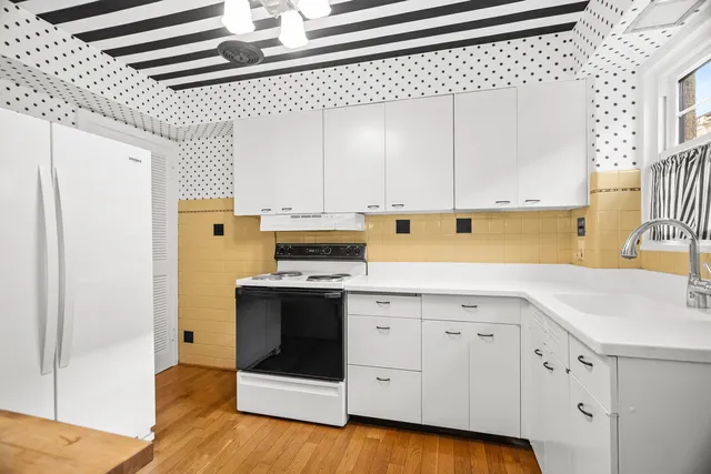 a kitchen with stainless steel appliances a stove a sink and a refrigerator
