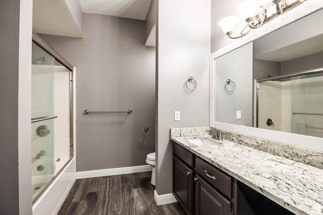 900 Bitner Road, Unit M 17 Park City, UT 84098 - Photo 10 of 29 Bathroom with vanity, dark wood finished floors, and combined bath / shower with glass door