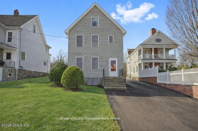 a front view of a house with a garden