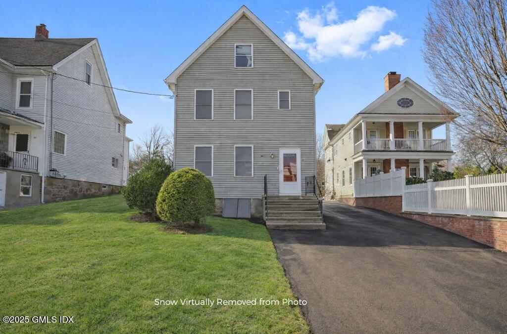 a front view of a house with a garden