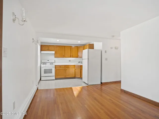a view of a kitchen with a sink and a refrigerator