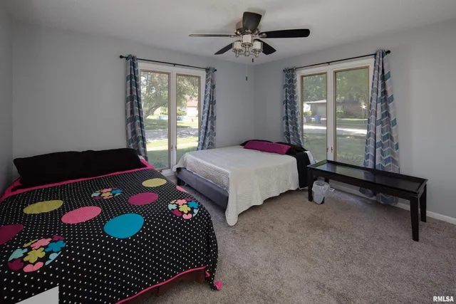 a bedroom with a bed dresser and a window