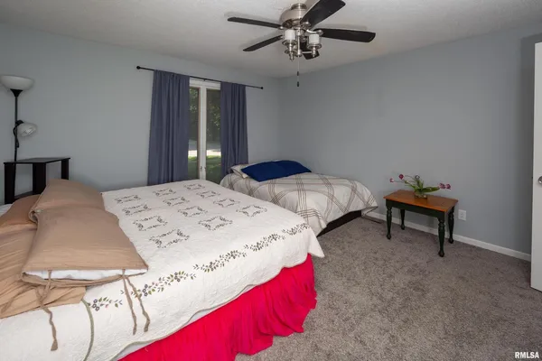 a bed sitting in a bedroom and chandelier