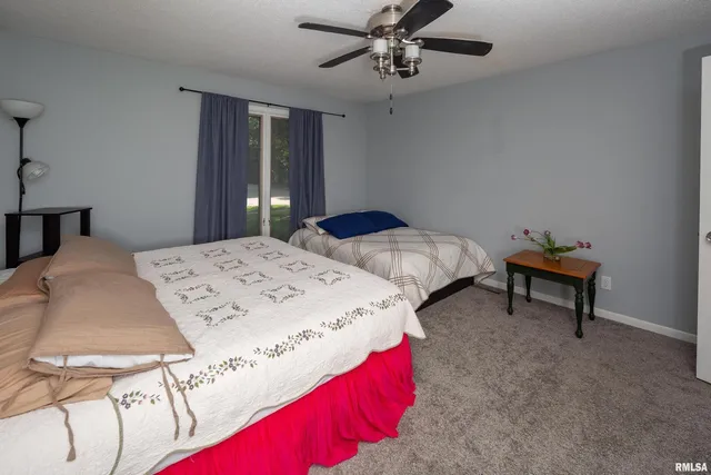 a bed sitting in a bedroom and chandelier