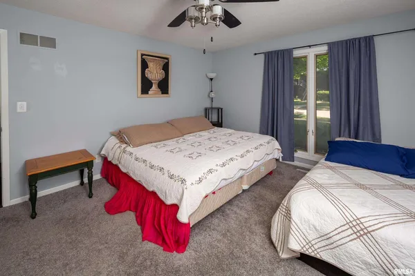a bedroom with bed and a window