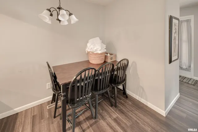 a view of a dining room with furniture wooden floor and a chandelier