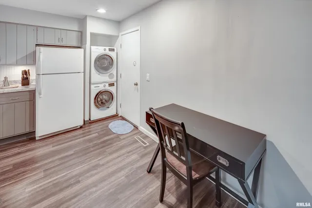 a view of a kitchen with a table and a refrigerator