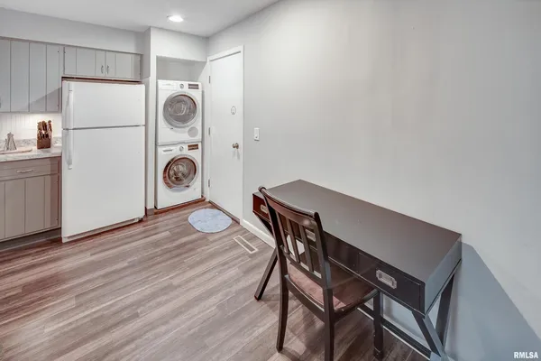 a view of a kitchen with a table and a refrigerator